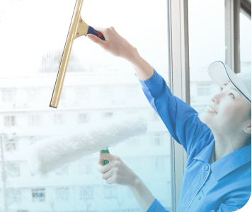 窓を掃除する女性